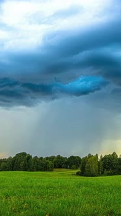 Dramatic Clouds Over Lush Green Field