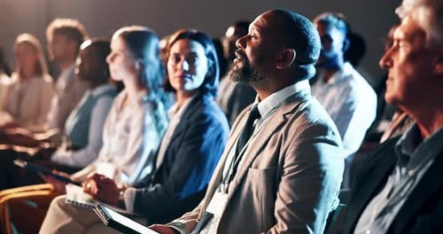 Audience, tablet and question with business man in auditorium for development seminar