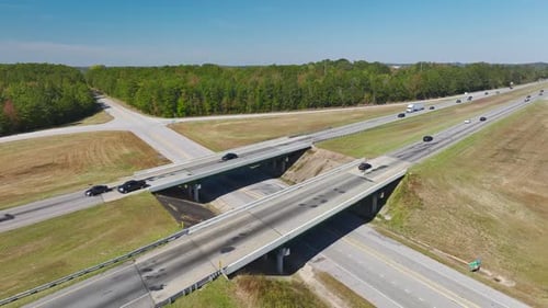 Aerial View of Freeway Overpass Junction with Fast Moving Traffic Cars and Trucks in American Rural