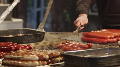 Sausages Cooking on Grill with Sparks