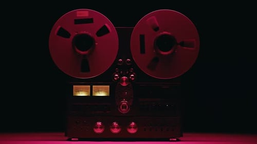 Vintage Reel-to-Reel Audio Recorder in Dark Setting