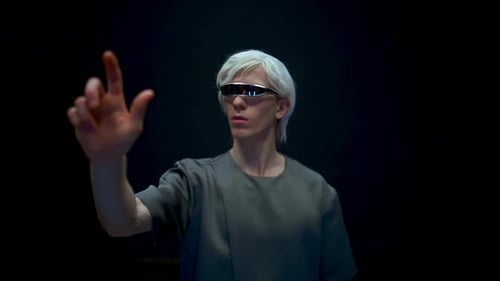 Young man with white hair touches virtual screen