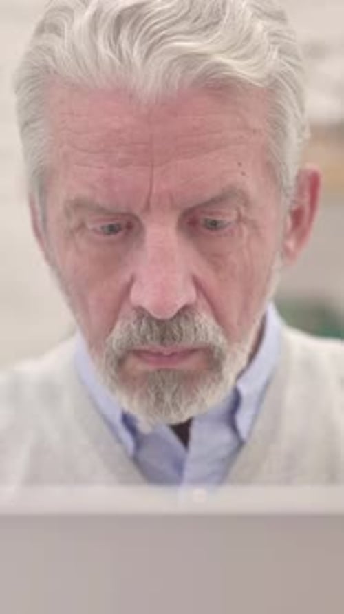 Close Up of Old Man Working on Laptop, Vertical Video