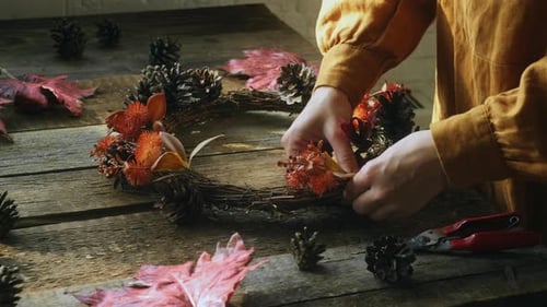 Hands Crafting a Festive Fall Wreath