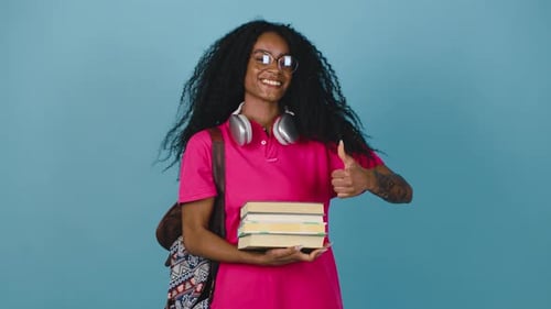 Smiling Student Holding Books in Studio