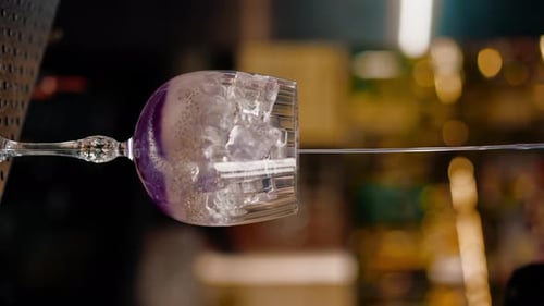 vertical video professional bartender creates a cocktail drink pours alcohol into a measuring glass