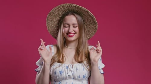 Smiling Woman Crossing Fingers for Good Luck