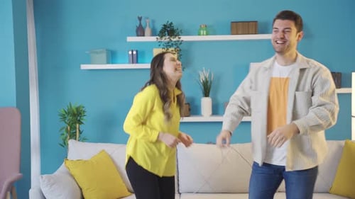 Cheerful Couple Dancing Happily in their Home