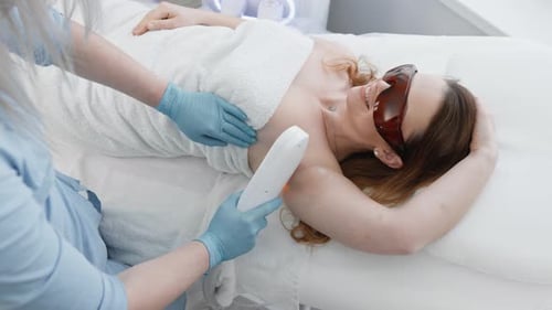 Woman Receives Laser Hair Removal Treatment in Spa