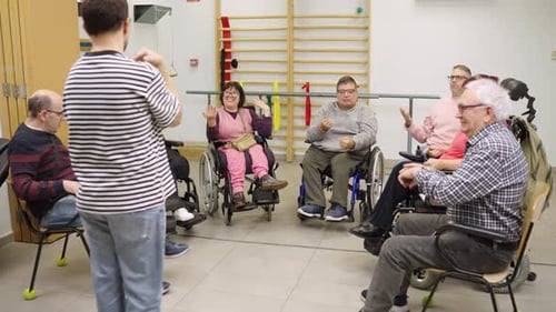 Group Doing Arm Exercises in Physical Therapy Setting