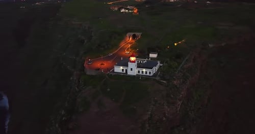 Aerial View to Working Lighthouse at Dusk Timelocated on a Picturesque Rock Lighthouse Ponta Do