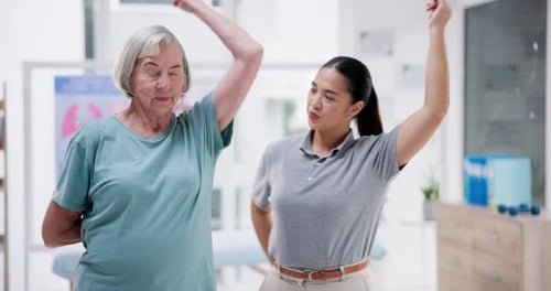 Senior Woman Practicing Arm Stretches with Therapist