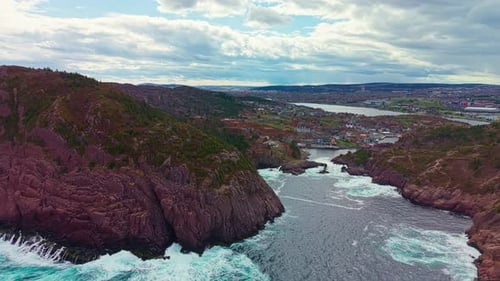 Aerial view over Quidi Vidi Harbour toward Signal Hill and St Johns cityscape beyond