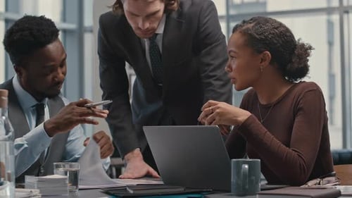 Professionals Collaborate at Urban Office Meeting