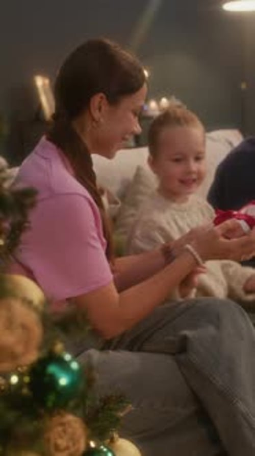 Mother and Child Exchanging Christmas Gifts at Home