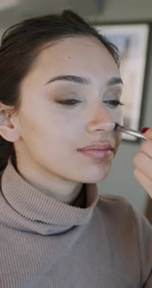 Applying Makeup with Skilled Artist Closeup View of Makeup Application Techniques Young Woman