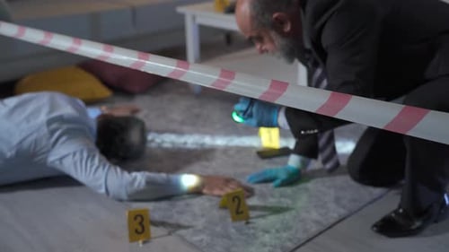 Crime Scene Investigation Examining Evidence with Flashlight