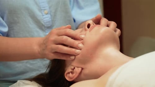 Woman Receiving a Rejuvenating Face Massage Treatment
