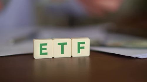 Concept of investing in Exchange Traded Funds. ETF initials with selective focus and money on the ba
