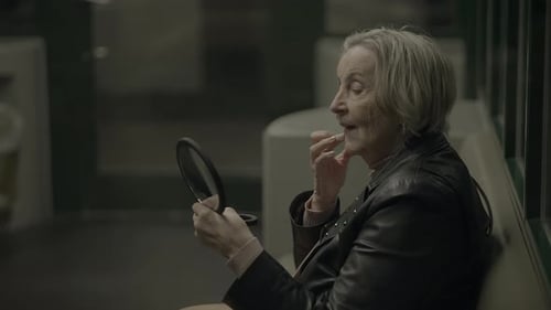 Senior Woman Checking Appearance with Mirror