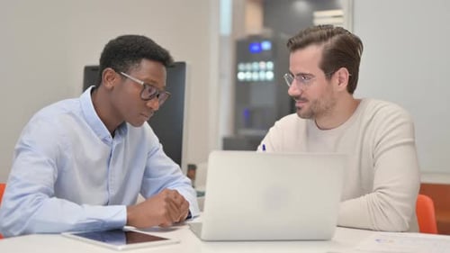 Business People Discussing Project while Sitting in Office