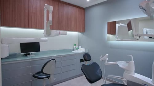 A Sleek and Modern Dental Office Featuring a Black Treatment Chair Advanced Medical Equipment a