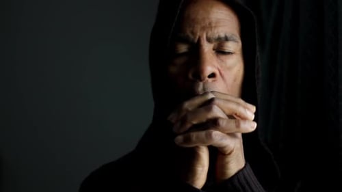 Man Praying Silently with Eyes Closed