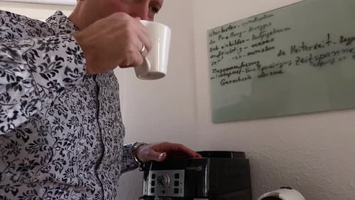 Man Drinks Coffee Near Espresso Machine Indoors
