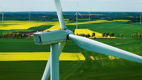 Wind Generators Producing Electricity in Countryside Closeup Turbine Blades Turning Steadily Above