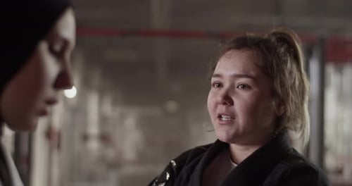 Women in Martial Arts Uniforms Talking