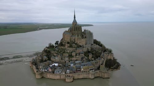 View of Mont Saint Michel during cloudy day, Normandy in France. Aerial backward