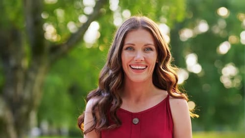 Woman with Long Wavy Hair Smiling Outside