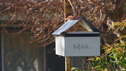 Worn Mailbox on a Sunny Day