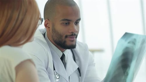 Doctor Consults with Patient About X-Ray