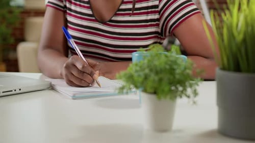Female Freelancer Taking Notes at Online School Webinar