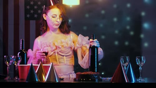 Young Woman Celebrates Alone with Cake and Wine