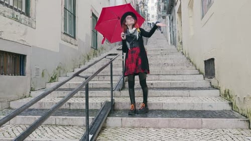 Stylish Woman with Red Umbrella Standing on Old City Stairs