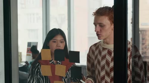 Team Brainstorming with Sticky Notes in Modern Office