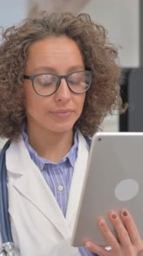 Doctor Using Tablet for Medical Work in Hospital