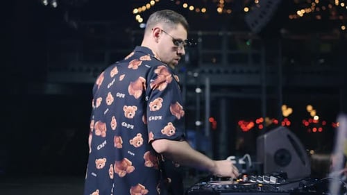 Portrait Of Cool DJ With Stylish Sunglasses Mixing Tracks DJ Playing Techno And Electronic Music