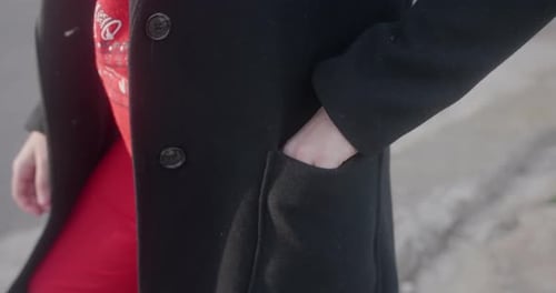 Close up of a woman's hand taking out a surgical mask out of her coat pocket. Coronavirus (Covid-19)