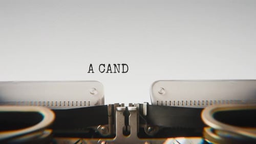 Old mechanical typewriter typing A Candle Burned Low in a close-up view.