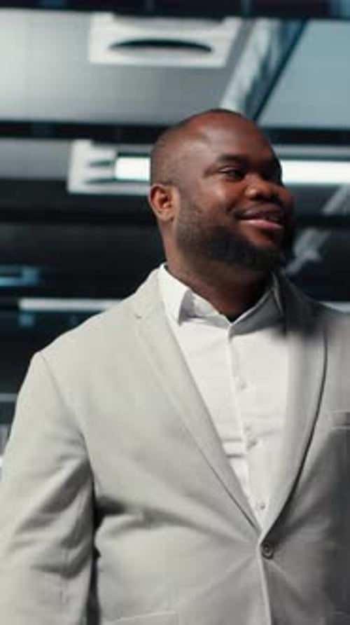 Vertical Video Smiling Engineer Walking in Data Center Checking Hardware for System Stability