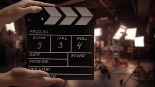 Human Hands are Using a Clapperboard on Set