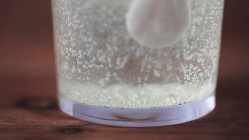 Effervescent Tablet Dissolving in Glass of Water
