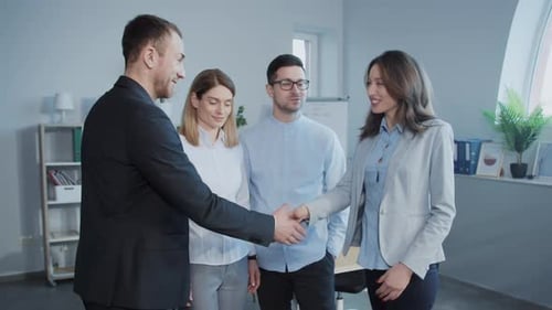 Business Team Shakes Hands in Modern Office