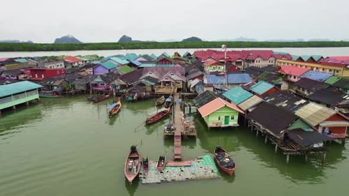 Aerial Pull Out Shot Over Floating Village at Panyee Island, Phang Nga Bay, Thailand.