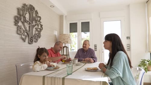 Family Eating Breakfast Together at the Dining Room Table
