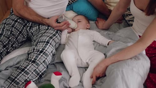 Family Bonding with Baby, Bottle Feeding on Bed