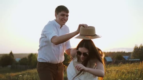Playful Couple Sharing a Lighthearted Moment at Sunset